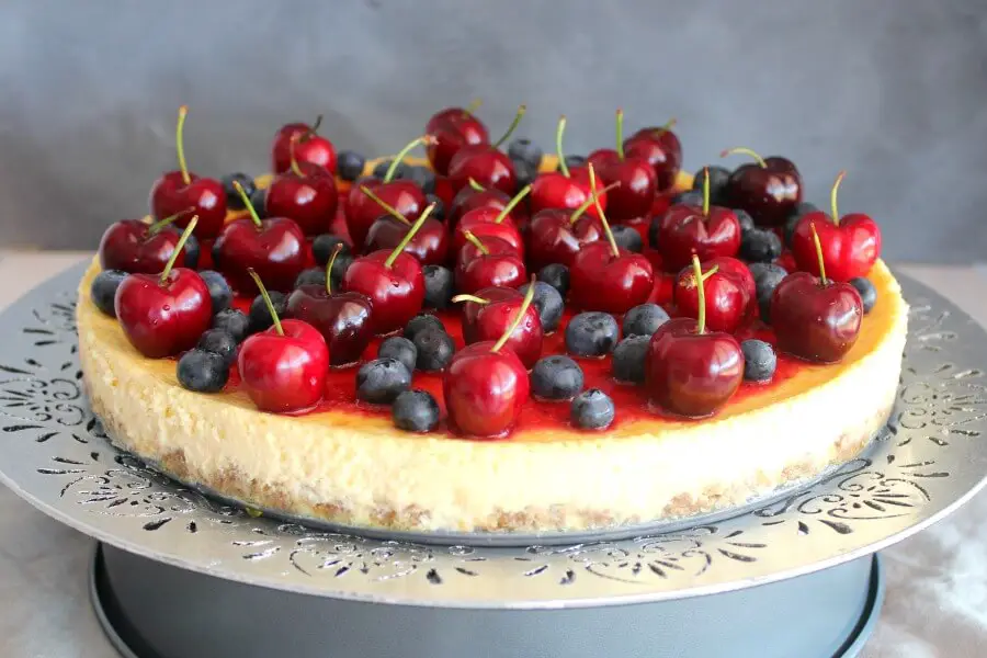 Baked Vanilla Cheesecake with Cherry Coulis. You won't believe how creamy & melt in your mouth this baked cheesecake is! It's super easy to make & absolutely perfect as a Christmas dessert | berrysweetlife.com