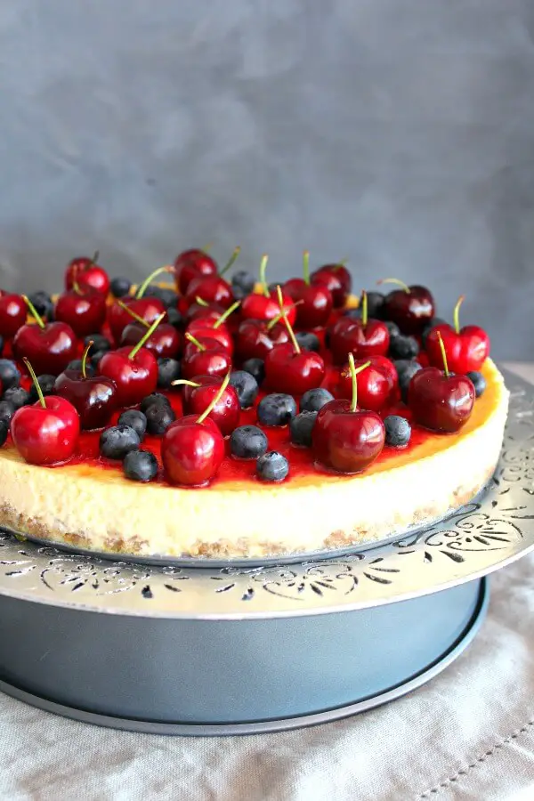 Baked Vanilla Cheesecake with Cherry Coulis. You won't believe how creamy & melt in your mouth this baked cheesecake is! It's super easy to make & absolutely perfect as a Christmas dessert | berrysweetlife.com