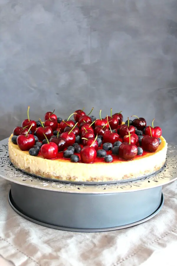 Baked Vanilla Cheesecake with Cherry Coulis. You won't believe how creamy & melt in your mouth this baked cheesecake is! It's super easy to make & absolutely perfect as a Christmas dessert | berrysweetlife.com