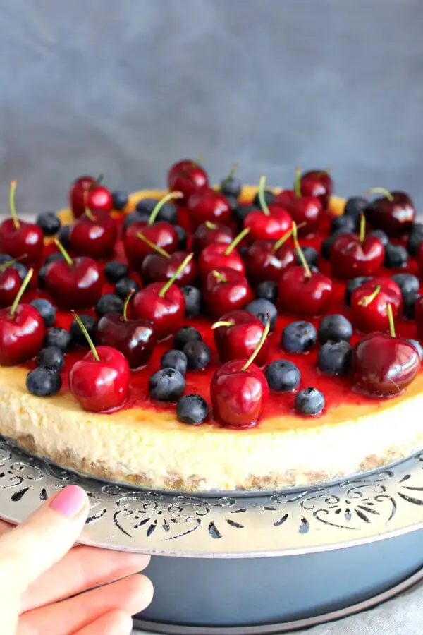 Baked Vanilla Cheesecake with Cherry Coulis. You won't believe how creamy & melt in your mouth this baked cheesecake is! It's super easy to make & absolutely perfect as a Christmas dessert | berrysweetlife.com