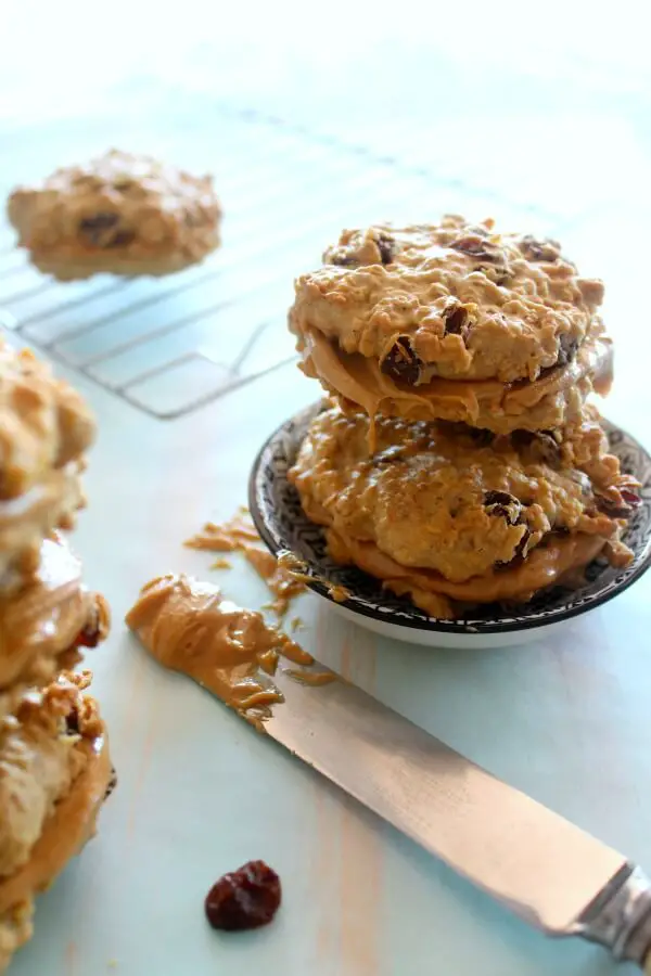 Oaty Raisin Peanut Butter Sandwich Cookies. Healthier oatmeal brown flour & raisin cookies with a peanut butter filling. A delicious snack or tea time treat. Your kids will love these! | berrysweetlife.com