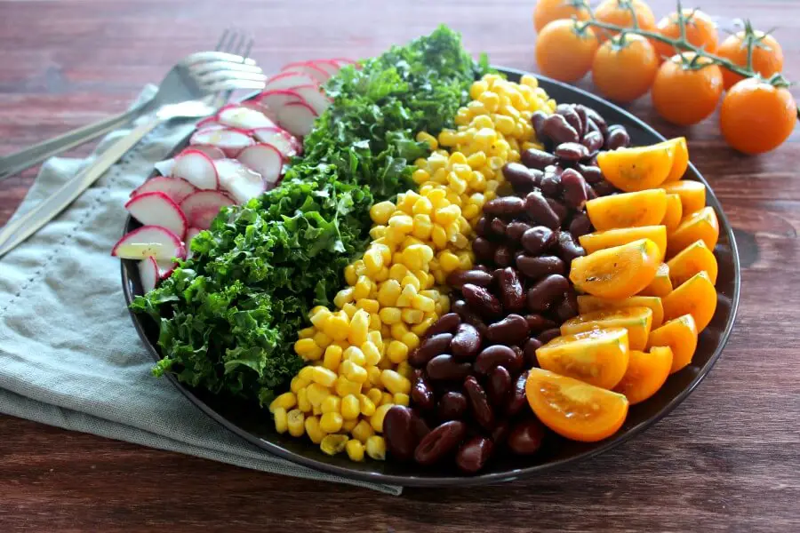 Mexican Chopped Corn, Vine Tomato & Kale Salad. A simple & tasty recipe with a Lemon & Honey Olive Oil Dressing. Perfect for a light lunch or as a side salad. The whole family will love this! | berrysweetlife.com