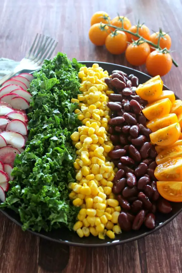 Mexican Chopped Corn, Vine Tomato & Kale Salad. A simple & tasty recipe with a Lemon & Honey Olive Oil Dressing. Perfect for a light lunch or as a side salad. The whole family will love this! | berrysweetlife.com