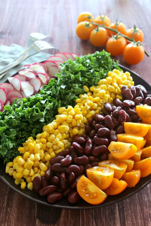 Mexican Chopped Corn, Vine Tomato & Kale Salad. A simple & tasty recipe with a Lemon & Honey Olive Oil Dressing. Perfect for a light lunch or as a side salad. The whole family will love this! | berrysweetlife.com