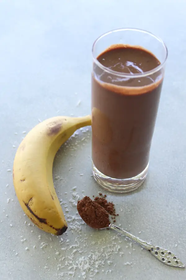 A super chocolatey, thick and creamy, healthy Chocolate Cinnamon Coconut Smoothie made with cocoa powder, bananas, dates, coconut milk. Dairy free, vegan | berrysweetlife.com