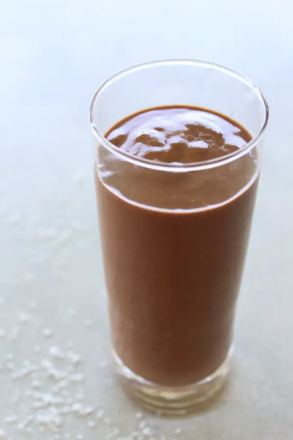 A super chocolatey, thick and creamy, healthy Chocolate Cinnamon Coconut Smoothie made with cocoa powder, bananas, dates, coconut milk. Dairy free, vegan | berrysweetlife.com