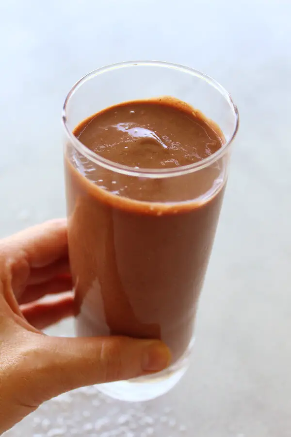 A super chocolatey, thick and creamy, healthy Chocolate Cinnamon Coconut Smoothie made with cocoa powder, bananas, dates, coconut milk. Dairy free, vegan | berrysweetlife.com