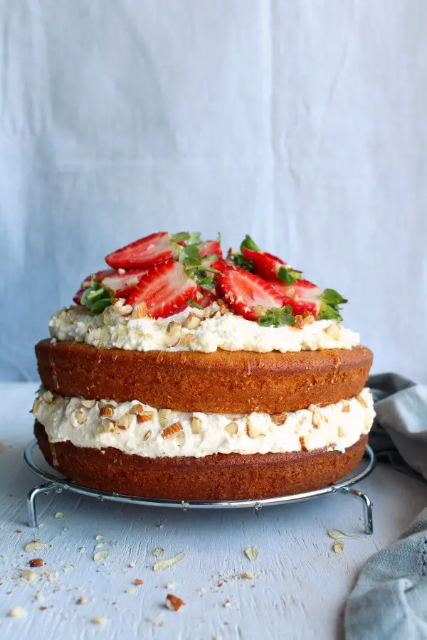 Zesty Orange Honey Layer Cake. The moistest, most tasty orange sponge cake with whipped cream & chopped almond layers & fresh strawberries on top. AMAZING! | berrysweetlife.com