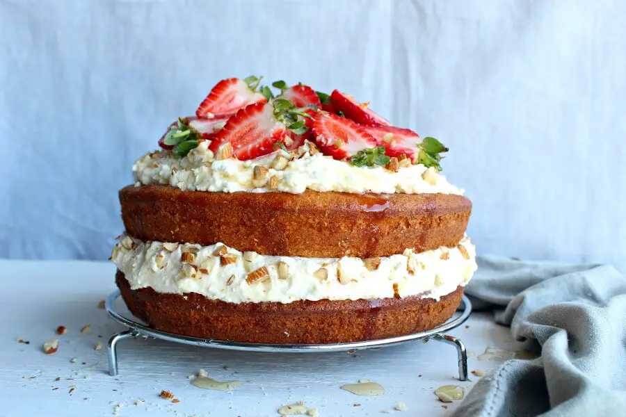 Zesty Orange Honey Layer Cake. The moistest, most tasty orange sponge cake with whipped cream & chopped almond layers & fresh strawberries on top. AMAZING! | berrysweetlife.com