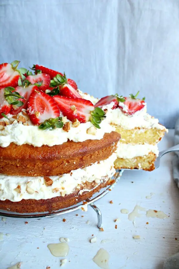 Zesty Orange Honey Layer Cake. The moistest, most tasty orange sponge cake with whipped cream & chopped almond layers & fresh strawberries on top. AMAZING! | berrysweetlife.com