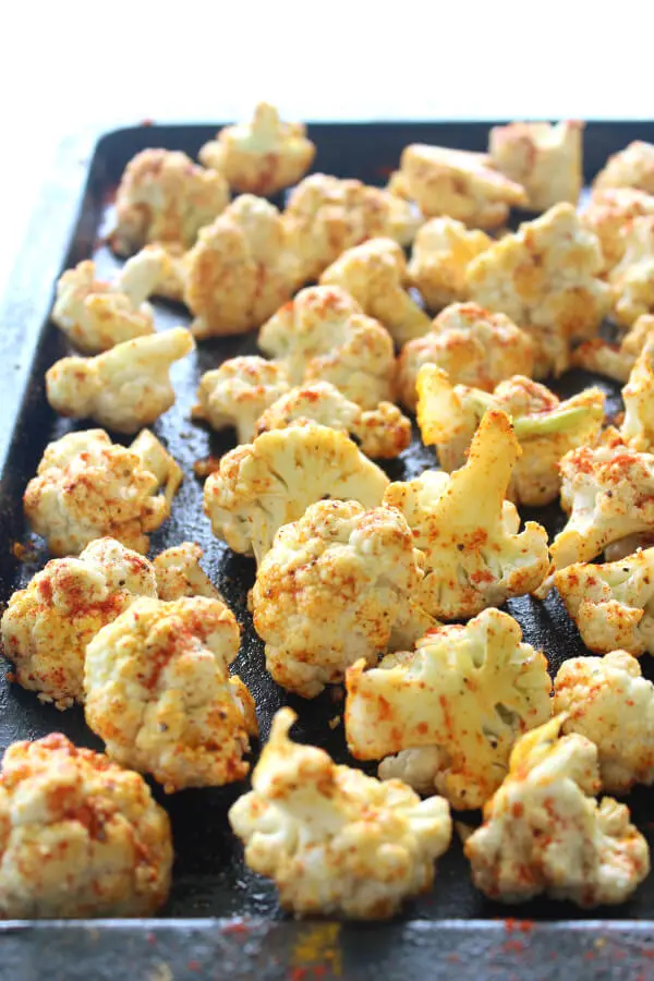 25 minute vegan Golden Spice Roasted Cauliflower is unbelievably delicious! Crispy on the edges, flavourful, and packed with vitamins, minerals, antioxidants and anti-inflammatories. Such an easy side dish! | berrysweetlife.com