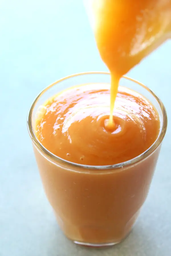 A vegan, easy to make Nourishing Mango Papaya Ginger Smoothie made with just 4 ingredients and your blender in 5 minutes! It tastes wonderful, is silky smooth, overflowing with healthy goodness | berrysweetlife.com